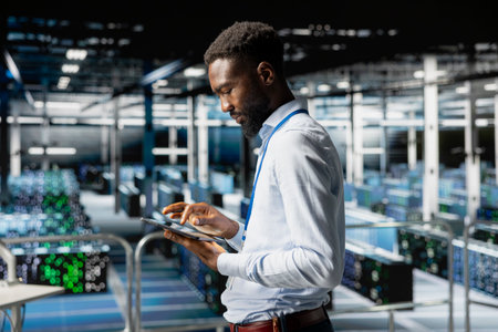 African american server hub worker checking code on tablet, reviewing AI LLM visualization on...