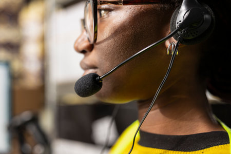 Close up of help line worker responding to issues like lost parcels or order tracking, surrounded by...