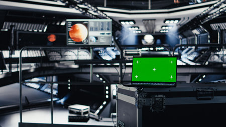 Close up of green screen mockup laptop in spacecraft on top of cargo container. Chroma key isolated screen notebook in futuristic spaceship during deep space mission operations, panning shotの写真素材