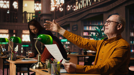 Elderly actor in a library focusing on script reading and memorization, preparing for a classic...