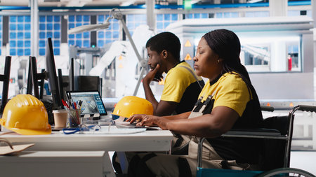 Woman with disability works in photovoltaics factory on designing solar cells, debugging and fixing malfunctioning systems. Plant worker wheelchair user ensuring operational reliability. Camera A.の写真素材