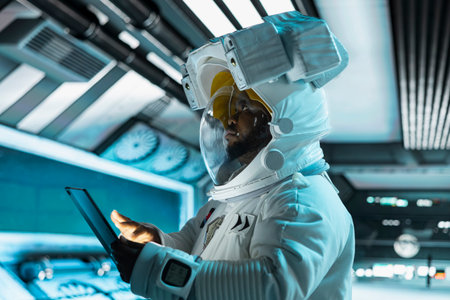 Astronaut wearing helmet doing galaxy observation using tablet during scientific mission in...