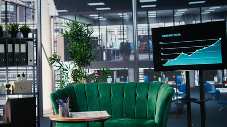 Formal work environment in a boardroom office arranged with chairs, table and office supplies for meeting preparation. Empty minimalist corporate interior ready for company use.の写真素材