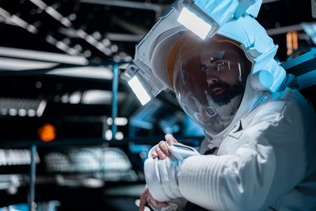 Cosmonaut in starship using communication systems integrated in suit during cosmic journey. Astronaut speaking in telecoms device, studying cosmic origins during long distance space travelの写真素材