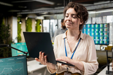 Woman administrator reviewing data reports and planning on laptop to build a new vision, focusing on...