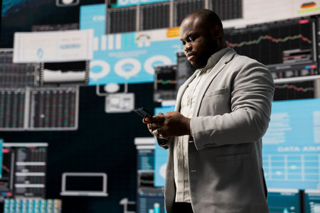 Black male business leader in a digital environment focused on charts, working on strategic planning...