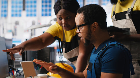 Photovoltaics facility employees evaluating performance of robot arms placing solar panels on assembly lines. Team looking at the production process on computer, solar plant. Camera A.の写真素材