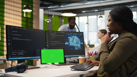 Admin using isolated screen tablet to code AI algorithms debugging software issues and improving system stability. Tech startup office worker using chroma key device, configuring settings, camera Aの写真素材