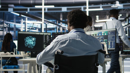 Server room programmer with paraplegia interprets AI generated data analytics graphs. Man in...