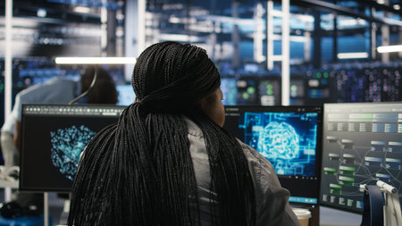 Data center staff member in office using AI deep learning algorithms to analyze datasets. African...