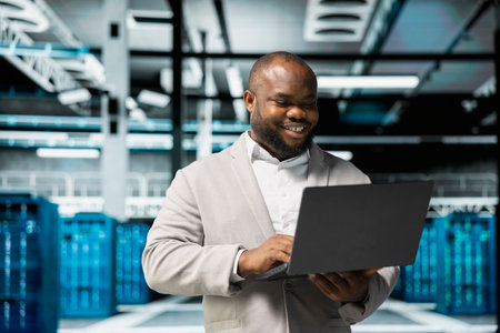 Smiling technician in data center workspace running system diagnostic tests and error checking...