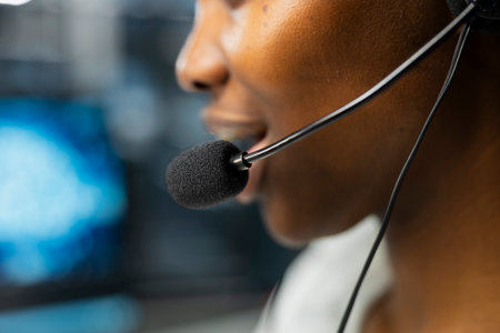 Extreme close up of headset microphone used by admin in data center to provide user technical support. Server hub worker talking in mic, assisting clients during remote callの写真素材