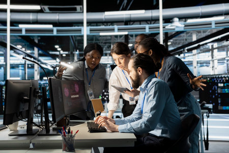Engineers reviewing AI systems alerts after detecting irregular network activity patterns. IT team...
