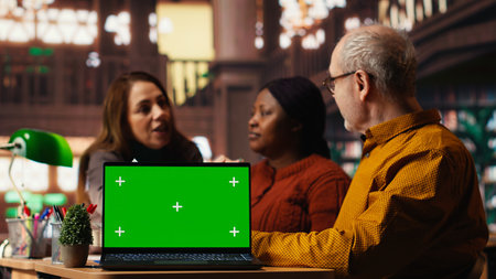 Colleagues practicing script reading in a public library, engaged in drama rehearsal and character development. Members preparing for classic theatre performance.の写真素材