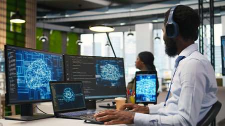 Computer scientist in office integrating AI machine learning systems to streamline workflows,...