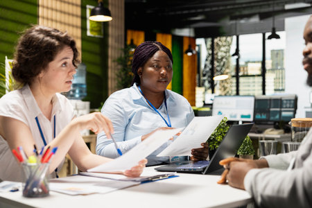 Recruiters interviewing a job seeker and reviewing qualifications, discussing talent acquisition in...