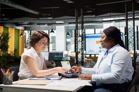 African american man receiving entrance card and employee ID badge from the HR department, completing the employment form and starting the onboarding process. Identification tag.の写真素材