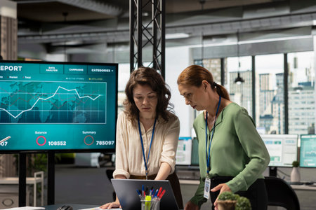 Corporate women team working on data analysis and setting project goals, empowered and ambitious coworkers doing business planning. Goals oriented collaboration drives modern success.の写真素材