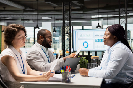Candidate and the hiring team in a recruiting meeting discussing interview questions and the opportunity for onboarding into the department workforce. Experience evaluation, head hunting.の写真素材