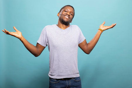 African american man standing and shrugging over an isolated background, expressing uncertainty....