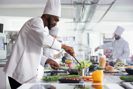 African American head chef cooking a savory dish in a stainless steel pan, using fresh produce and...