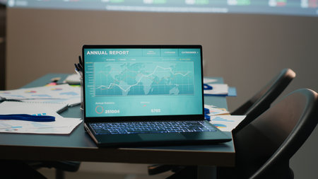 Modern corporate space sits empty after hours with forecasting charts and business analytics...