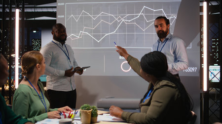 Group of business associates preparing their forecast pitch for a discussion with investors,...
