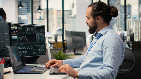 Trader in office leverages artificial intelligence on laptop to interpret charts, optimizing buying and selling. Stockbroker uses deep learning automatization on notebook to maximize profitsの写真素材