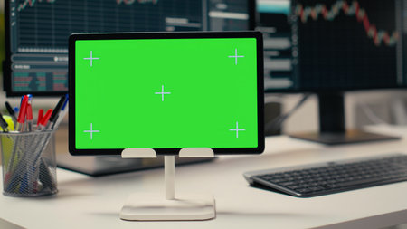 Trading software in prop firm office with graphs on isolated screen tablet. Mockup device on desk used by financial experts tracking stock market activity using analytical toolsの写真素材