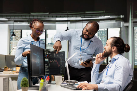 Team of day traders brainstorming in office, doing strategy to capitalize on market fluctuations. Teamworking proprietary firm colleagues analyzing stock exchange price movements for fast profitの写真素材