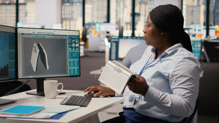 Product developer in office using advanced solar cell technology to create renewable energy based...
