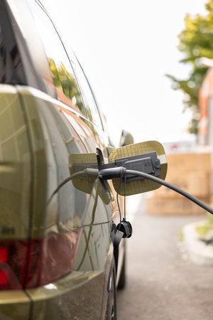 Close up of vehicle inlet port of electric automobile used to do refilling using clean energy...