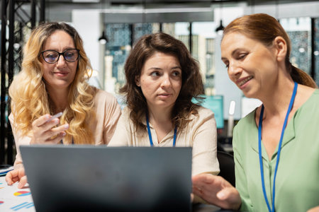 Team of diverse colleagues aligning objectives with data reports, reviewing financial performance data to lead company toward success in a smart and collaborative work environment.の写真素材