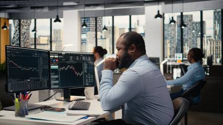 Trader in emotional turmoil concerned by investment portfolio value drop after unexpected market crash. Anxious man distressed by stock exchange account shares price fluctuationの写真素材