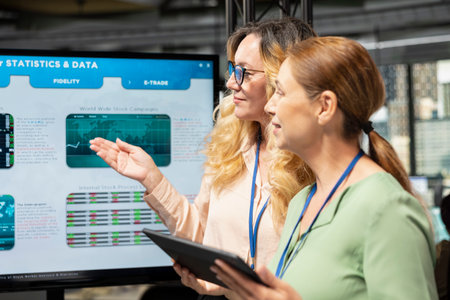 Empowered business associates planning a project with development goals, meeting in a boardroom to review data insights and performance indicators for multinational company growth.の写真素材