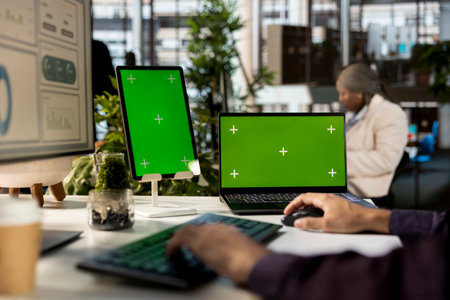 Middle eastern corporate expert focuses on data management next to mockup, planning a global expansion strategy for company growth. Aligning business goals with performance metrics.の写真素材