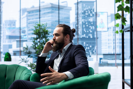 Corporate administrator in negotiation over the phone line, finalizing an agreement with partners after analyzing data and risks. Contacting people regarding international business.の写真素材