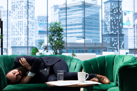 Corporate boss faces burnout and struggles with money loss and economic problems affecting his business, showing the panic and depression of high level management. Hedge fund risks.の写真素材