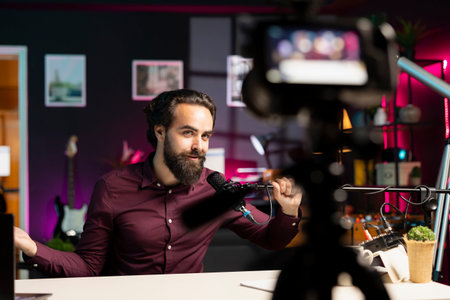 Content creator adjusting professional microphone in studio before starting recording video for...