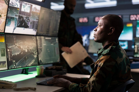 Counterterrorism division operative wearing camouflage uniform using target acquisition tech to detect enemy location. Defense security expert using satellite hardware to track dangerous threatsの写真素材