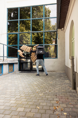 Delivery man losing control of a massive pizza package while approaching the customer door. Stack...