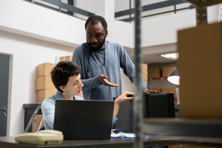 Diverse small business workers overseeing product handling, focusing on business operations in a...
