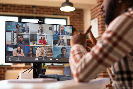 Self employed black man sits in living room during virtual webinar, presenting ideas with global...