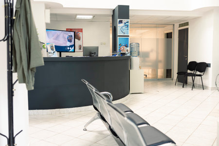 Empty hospital reception desk in clinic waiting room, used to assist patients with appointments and...