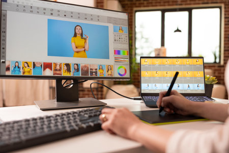Closeup of photographer using stylus on touchscreen tablet for retouching image tones and...