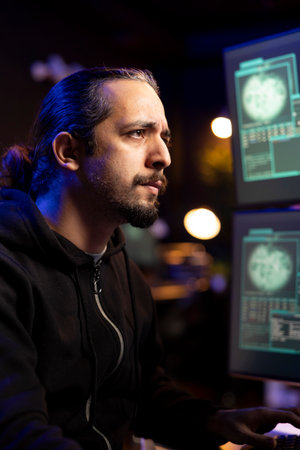 Hacker frowning after being unable to do phishing attacks and trick users into revealing credit card data. Man annoyed after DDoS attacks fail to flood servers and crash websitesの写真素材