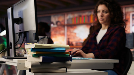Close up of stacked books on startup office desk used by entrepreneur to study and learn how to grow...
