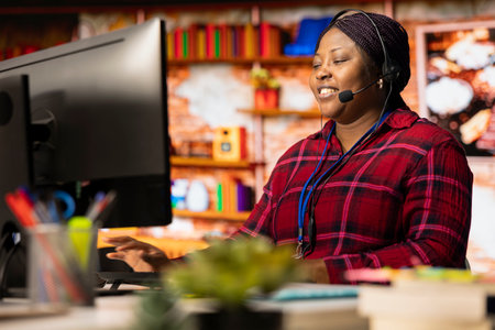 Smiling call center agent talking in headset microphone, helping customers regain access to accounts...