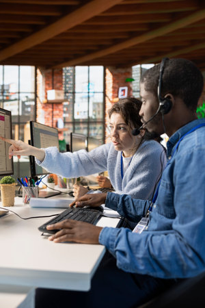 Team of call center agents collaborating to answer customers technical inquiries about hardware...