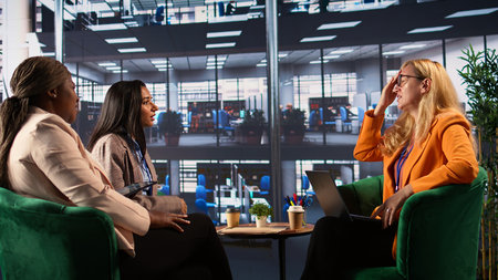 Female executive feeling sick and exhausted in a meeting to discuss strategies and corporate growth. Leader in a diverse work environment having a migraine and being overworked. Camera B.の写真素材